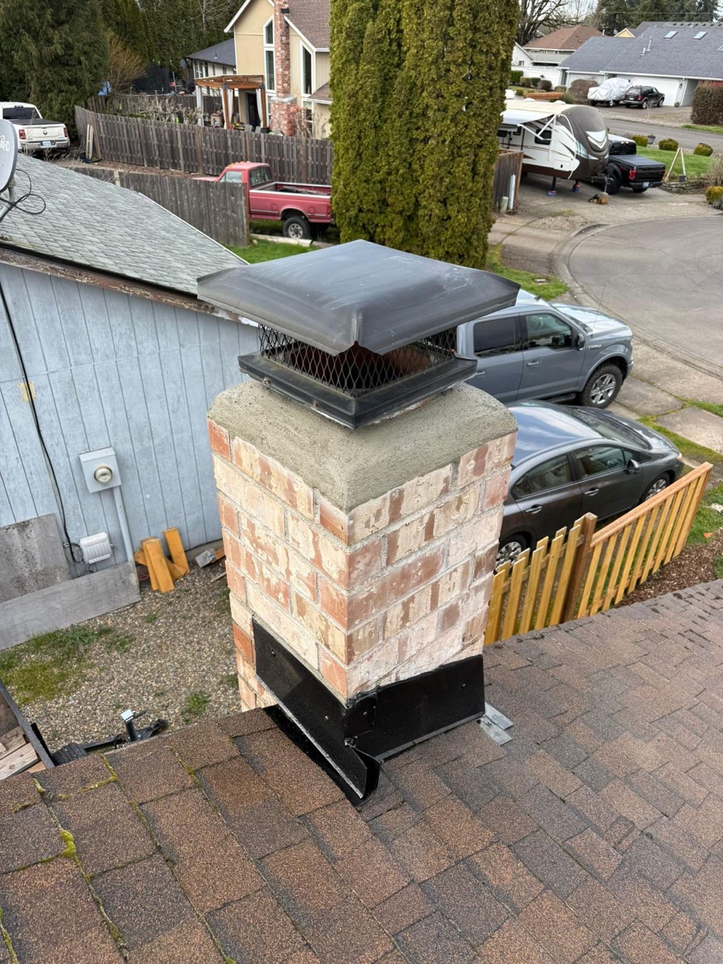 Chimney rebuild with new cap over the garage